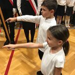 Uczniowie z wyciągniętymi prawymi dłońmi mówią przysięgę ucznia.