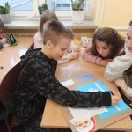 Uczniowie pracują nad grą planszową.
