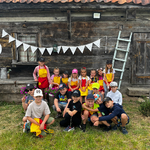 klasa 1b pozuje do zdjęcia na tle starego domu