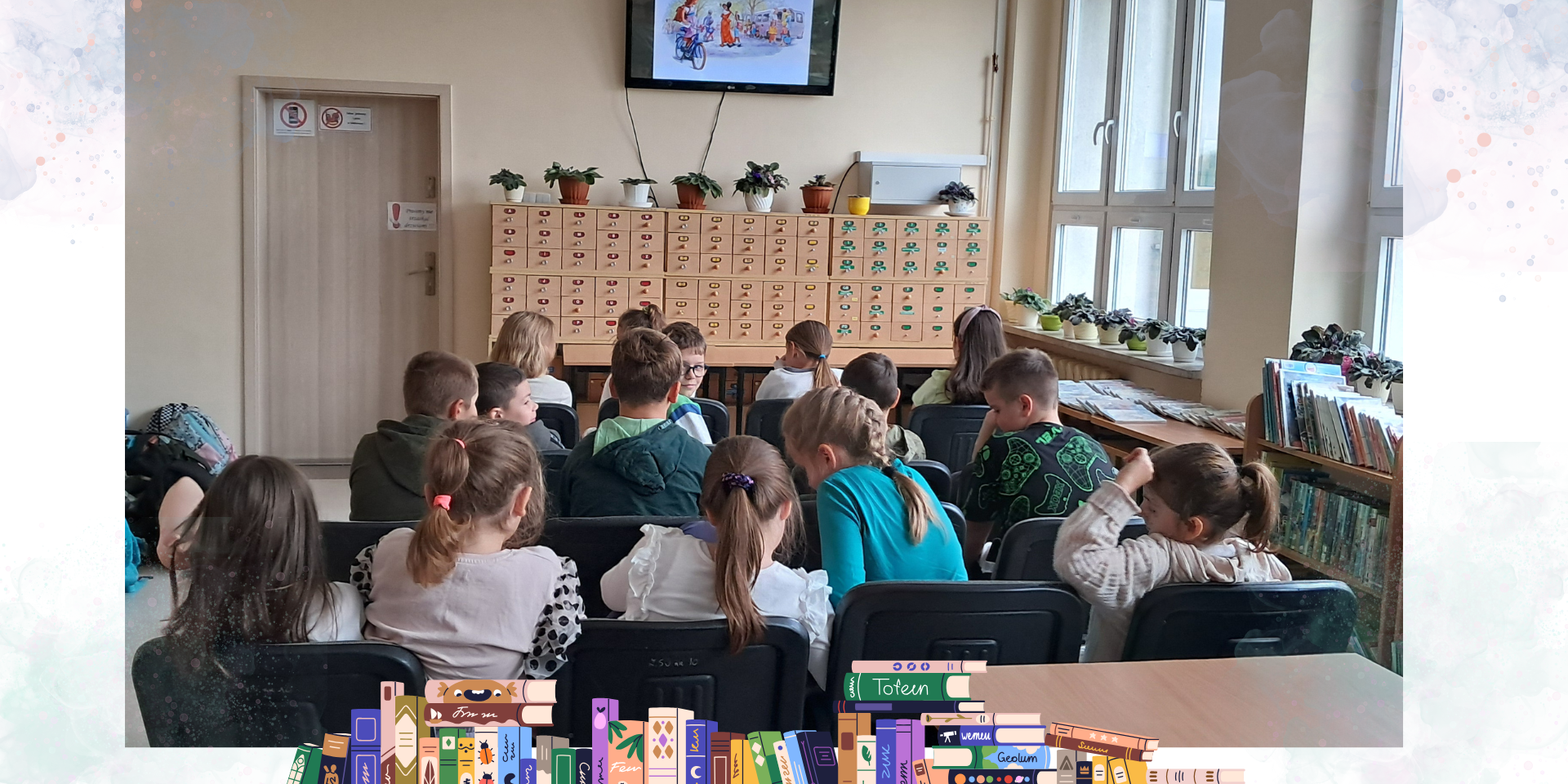 Dzieci siedzą w bibliotece i słuchają czytanej bajki