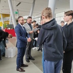 Uczniowie odbierają dyplom uczestnictwa od komisji