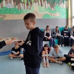 Nauczyciel wręcza uczniowi dyplom.