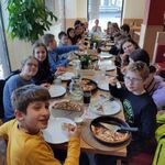 uczniowie jedzą pizzę